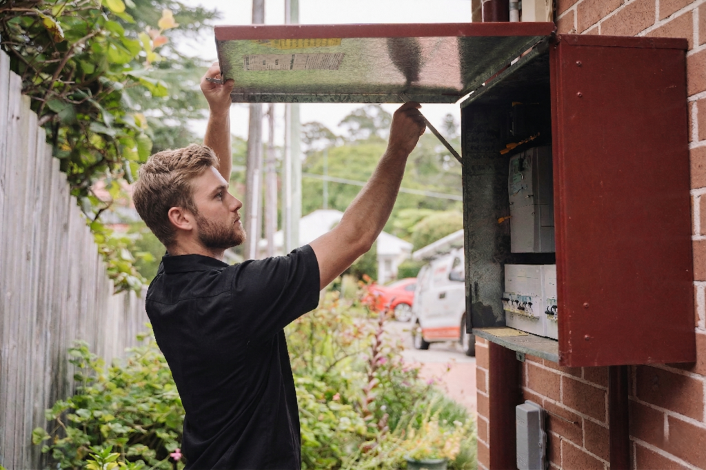 Electrician installing downlights in a Lilyfield home